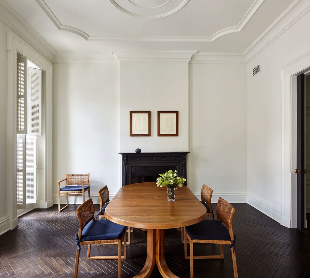 white dining room with long wood table