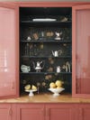 rosey red cabinet with floral shelves