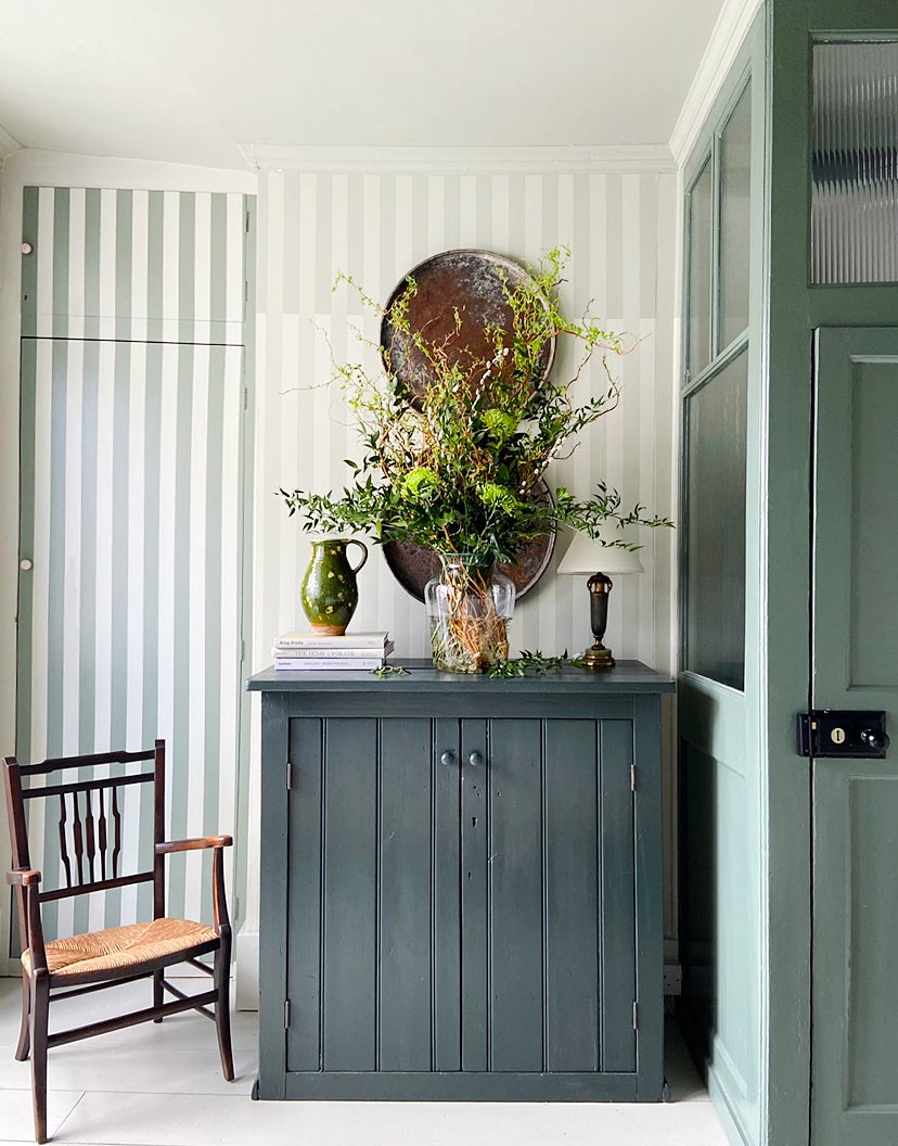striped wall and teal dresser