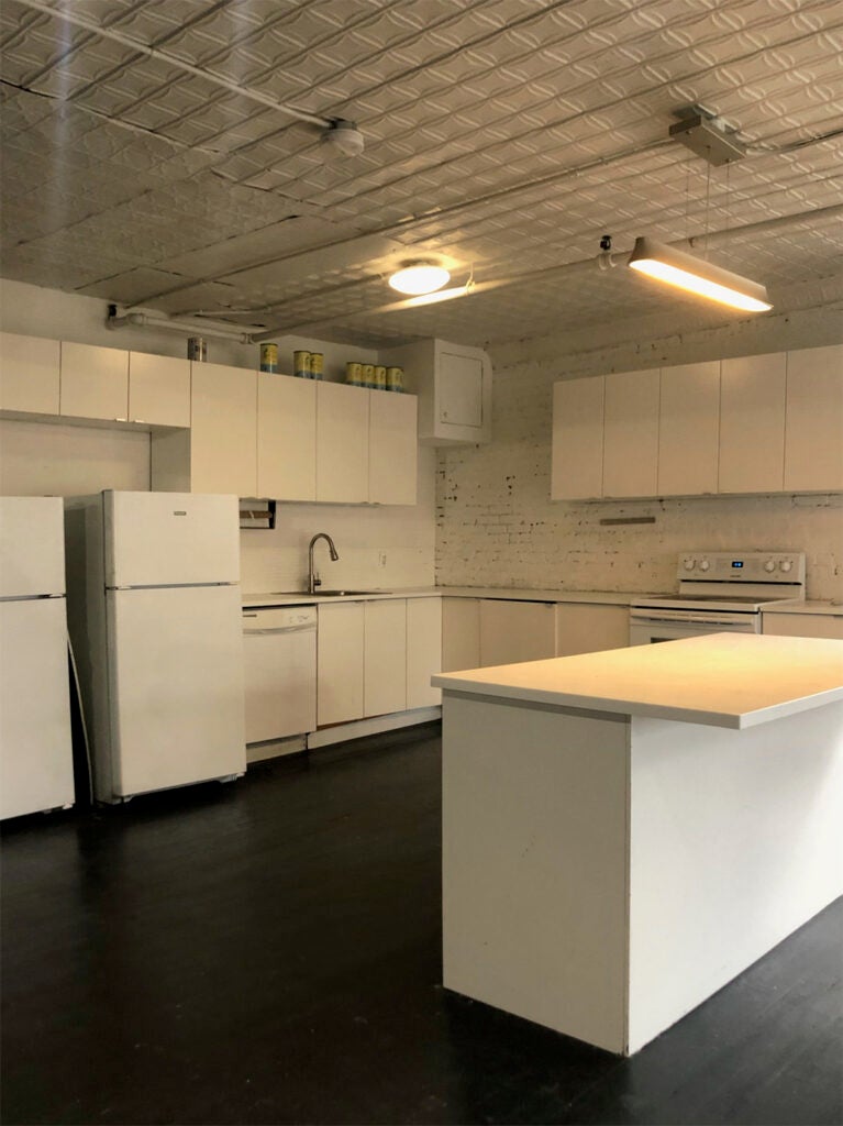 white kitchen with dark floors