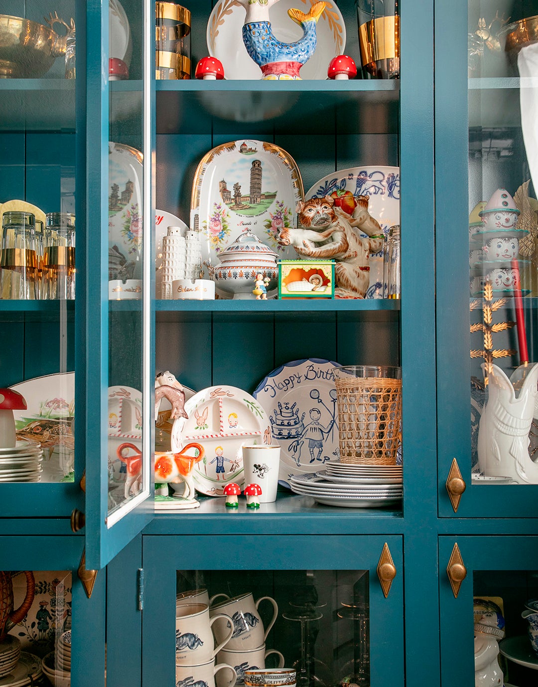 teal cabinets filled with china