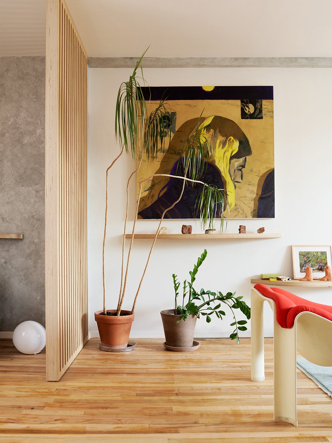 Painting in Living Room with Wood Floors and Plywood Wall Divider by Tangible Space