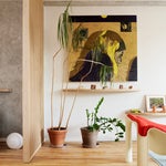 Painting in Living Room with Wood Floors and Plywood Wall Divider by Tangible Space