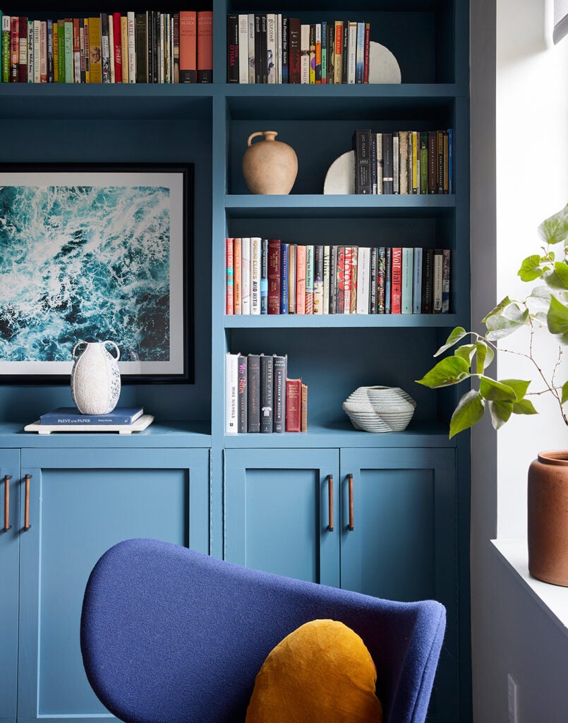 bookshelves with blue armchair