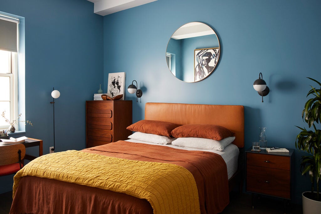 blue bedroom with terracotta bedding