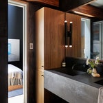 dark bathroom vanity with wood cabinet