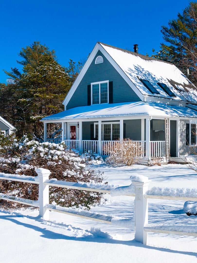snowy exterior of blue home