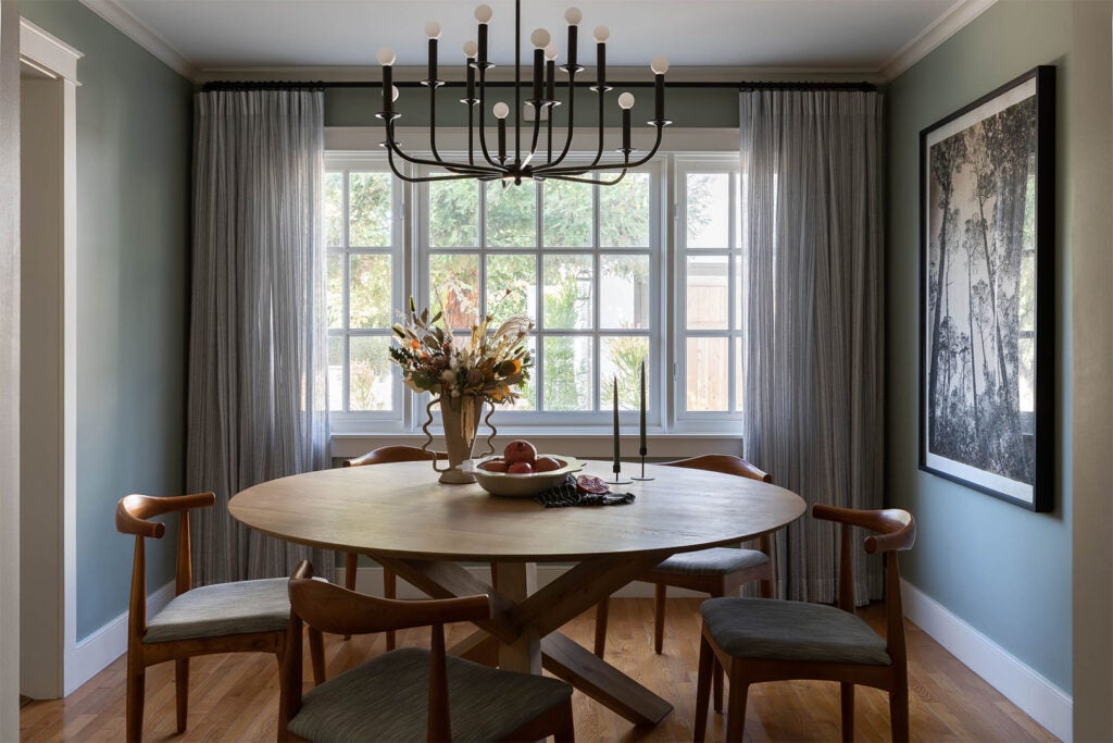 sage green dining room with round table
