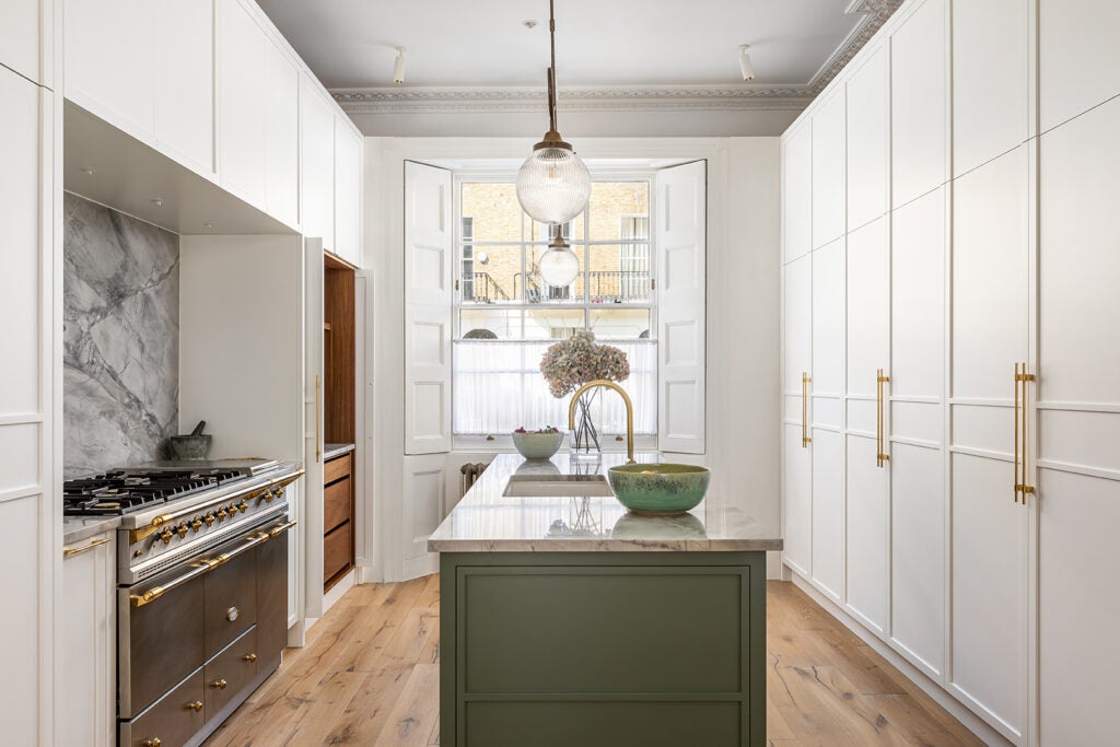 white kitchen with wall of pantry doors