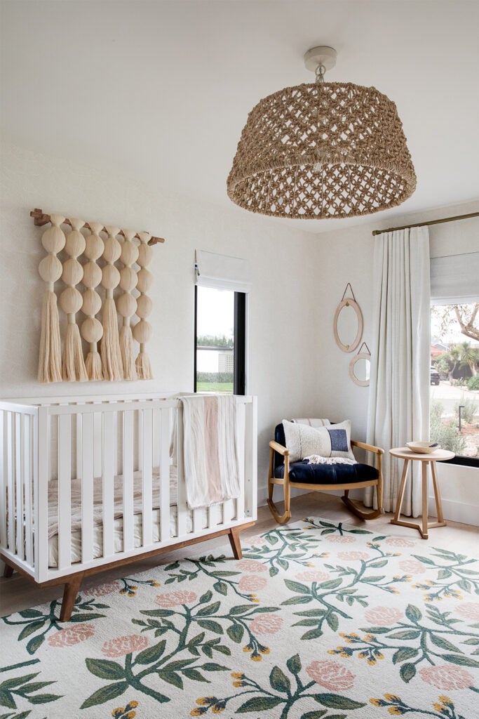 white crib and floral rug