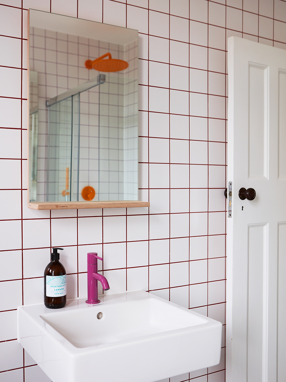 Purple Grout and a Mango Showerhead Infuse This Shared Family Bathroom With Fun