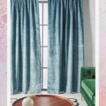 Matte Blue Velvet Curtains behind Green Sofa and Wood Coffee Table