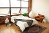 bedroom with large industrial windows