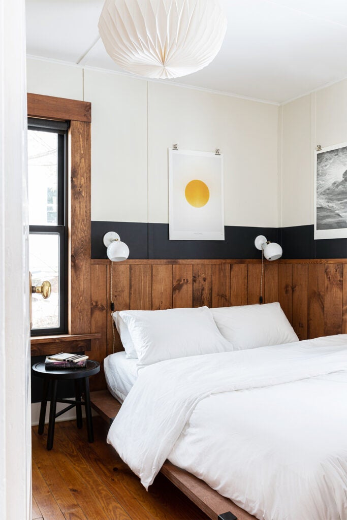 small bedroom with wood paneling