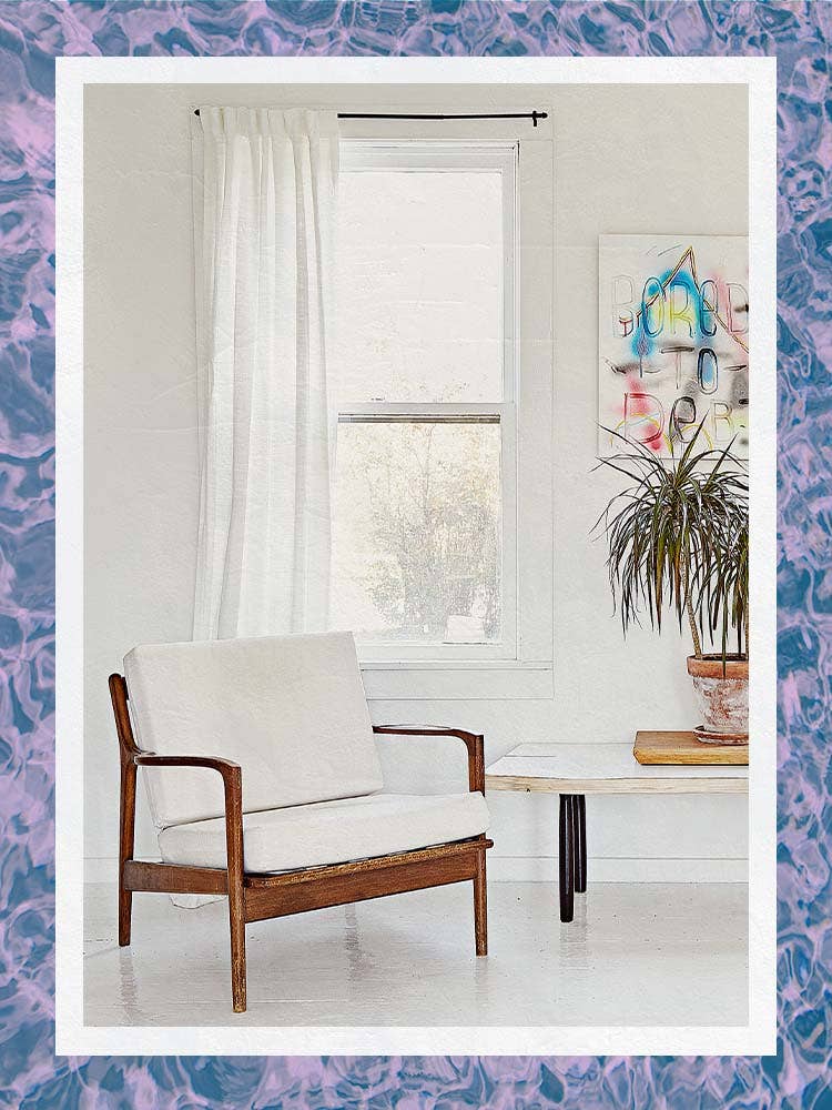 Single White Curtain Panel Behind Wood Frame Chair and Table