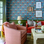 Floral Wallpaper Room with Red Sofa and Pink Chair and Green Trim