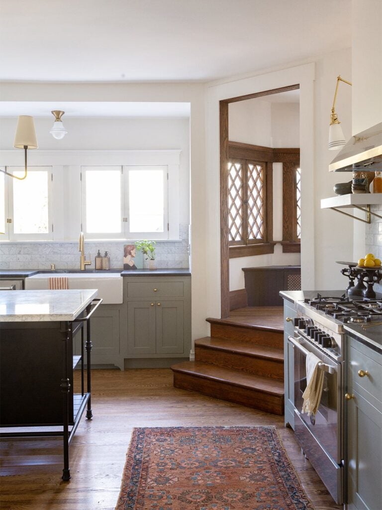 Craftsman LA Home with white farmhouse sink in green kitchen