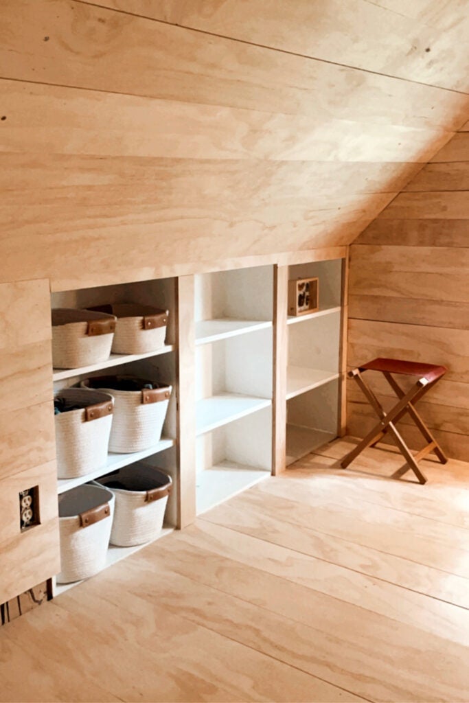 built-in bookcase with bins for clothes
