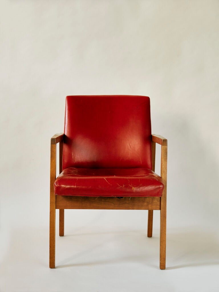 red vinyl chair with wooden arms legs straight view
