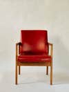 red vinyl chair with wooden arms legs straight view