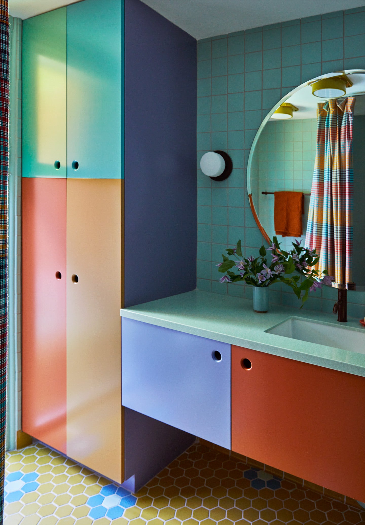bathroom with color blocked cabinets