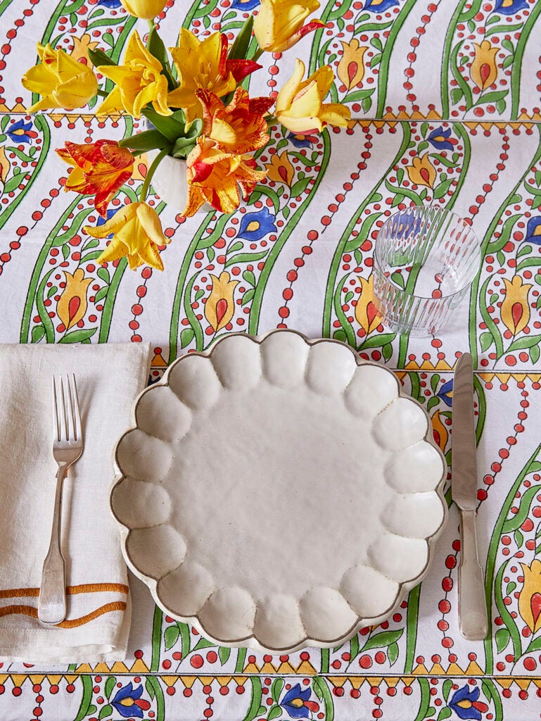 white dinner plate orange flower centerpiece on Selin Blockprinted Tablecloth
