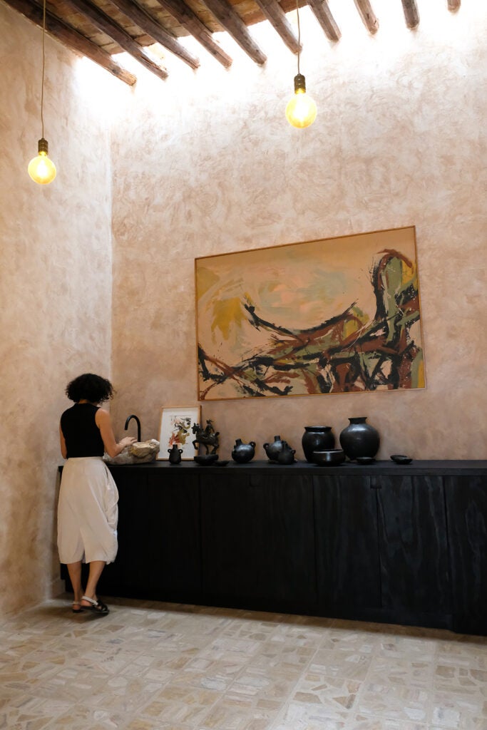 Woman with ceramics at Stellah Gallery