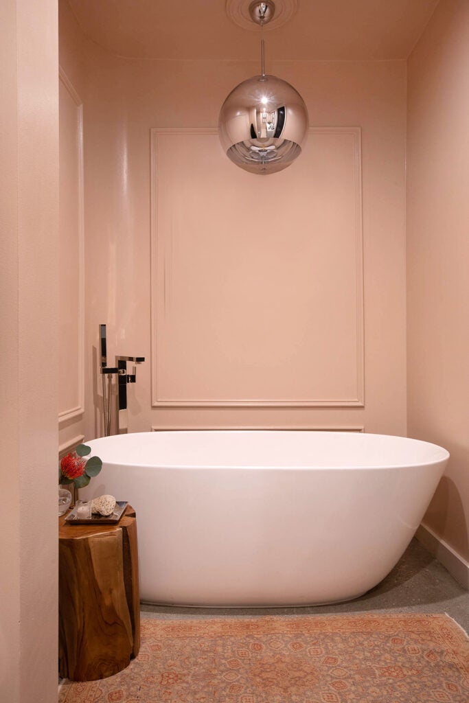 bathtub surrounded by pink walls