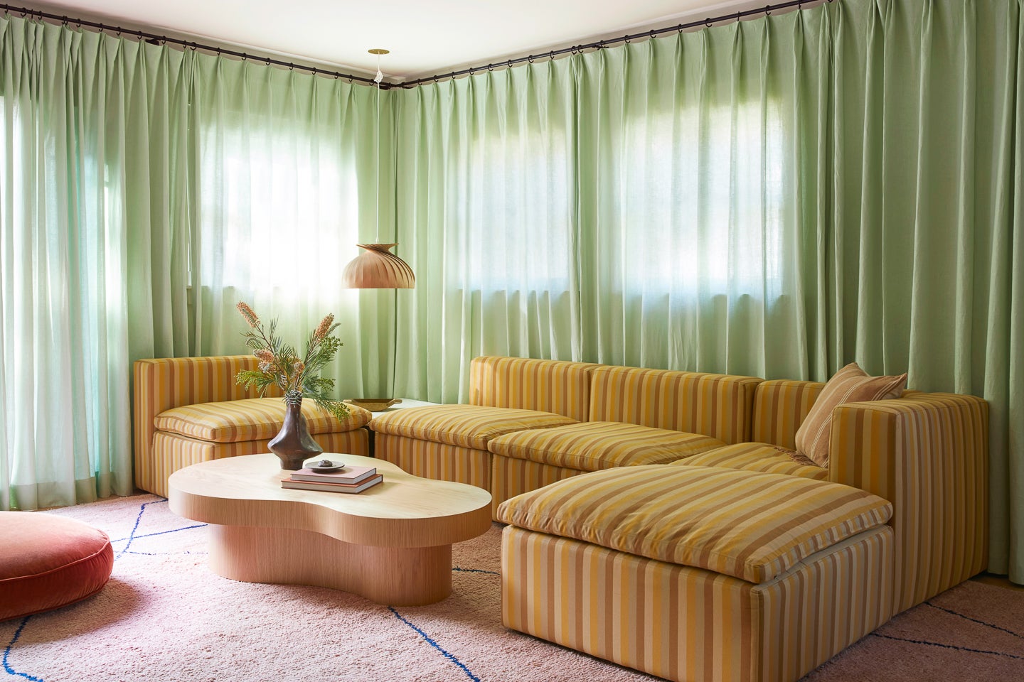 green curtains behind sofa