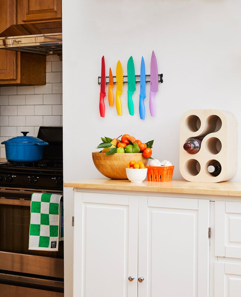 white kitchen island with rainbow knives