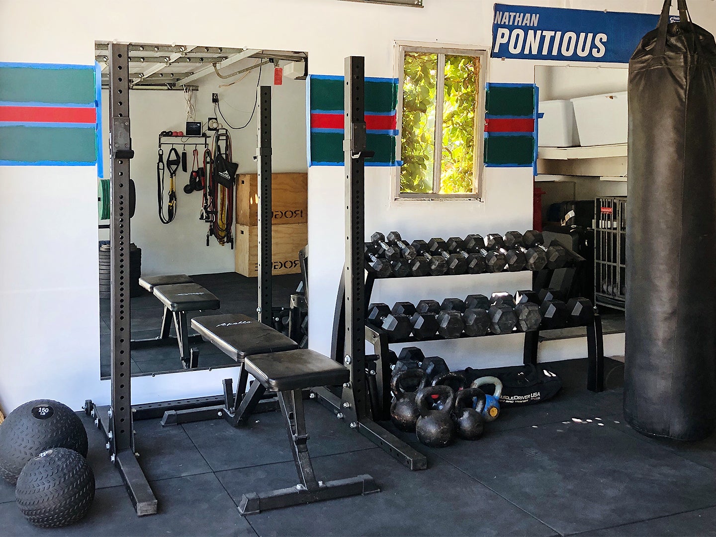 Wall-to-Wall Built-Ins Hide All the Utilitarian Odds and Ends in This Garage-Turned-Gym
