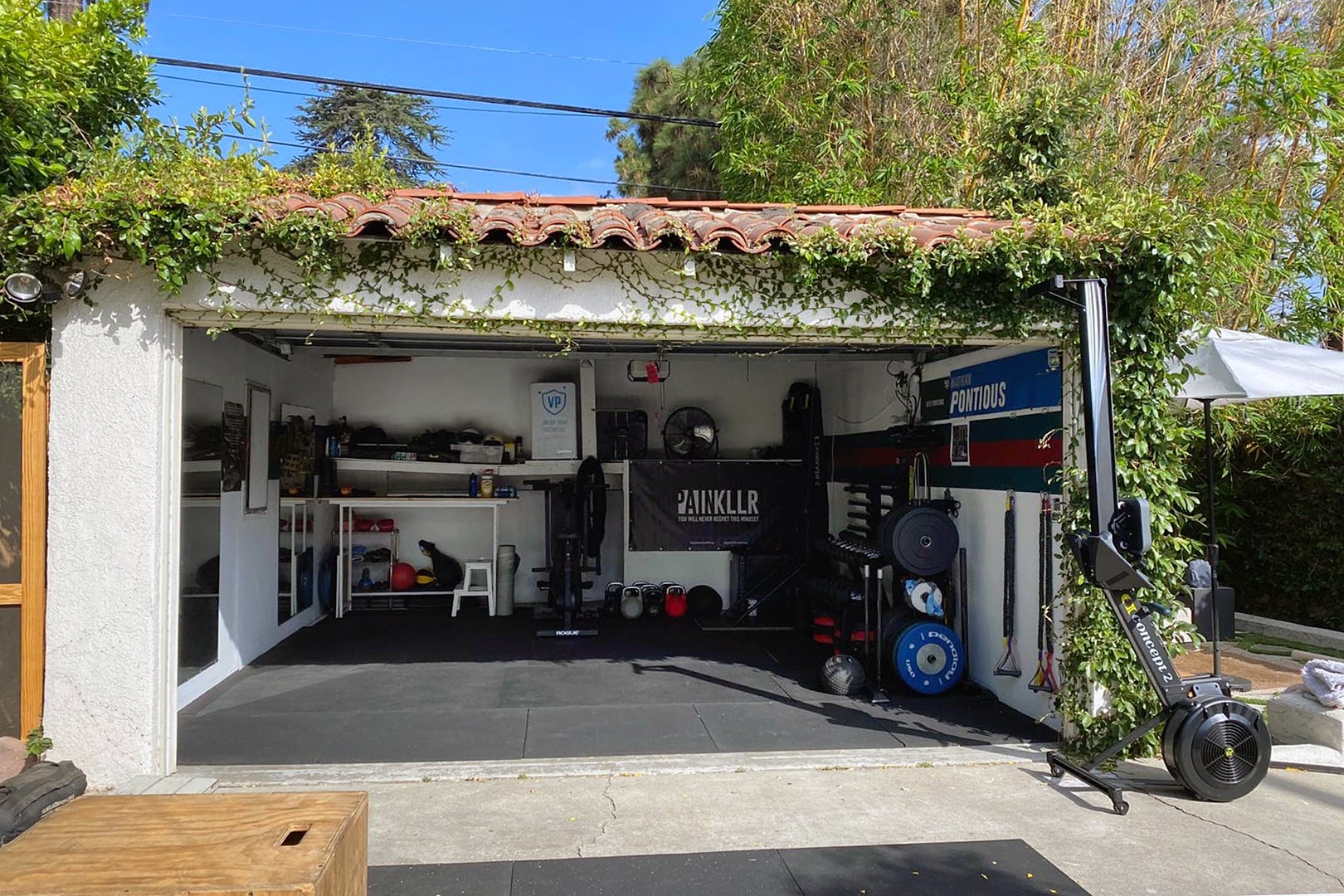 Wall-to-Wall Built-Ins Hide All the Utilitarian Odds and Ends in This Garage-Turned-Gym