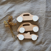 3 wood toy cars with white wheels