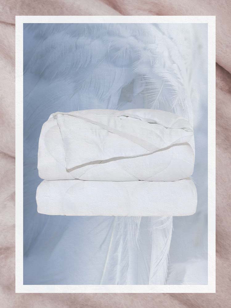 White tencel mattress protector in cloud like background