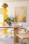 Pink marble dining table with artwork on wall