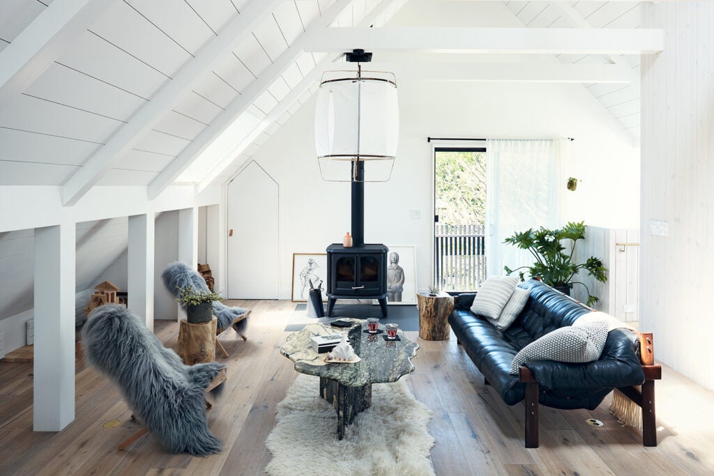 main living room with leather sofa and wood burning stove 