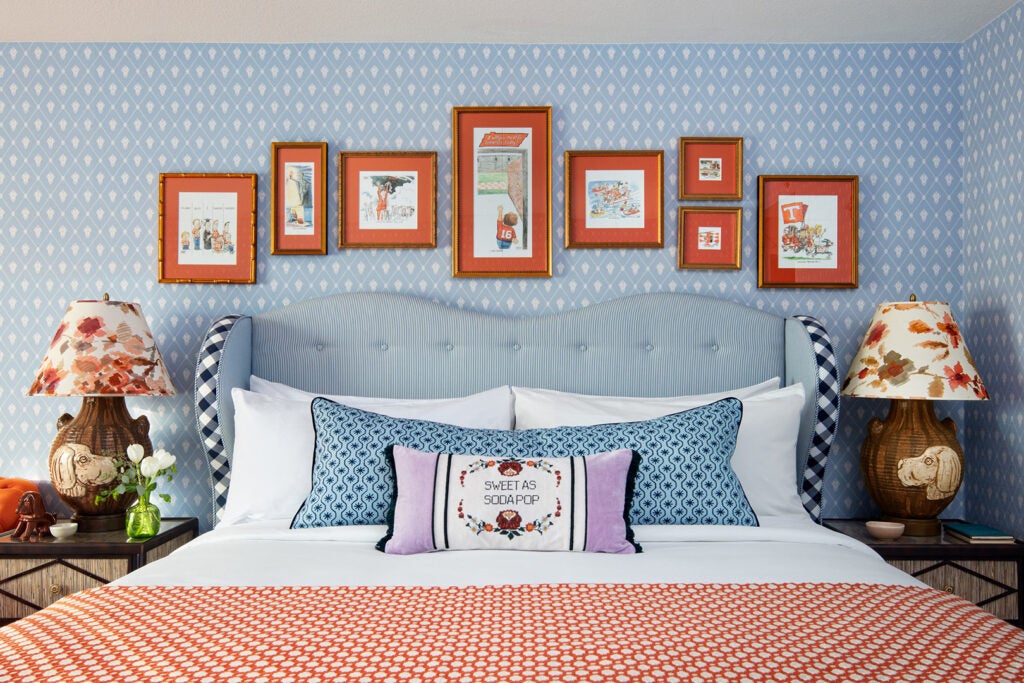 blue bedroom with orange artwork