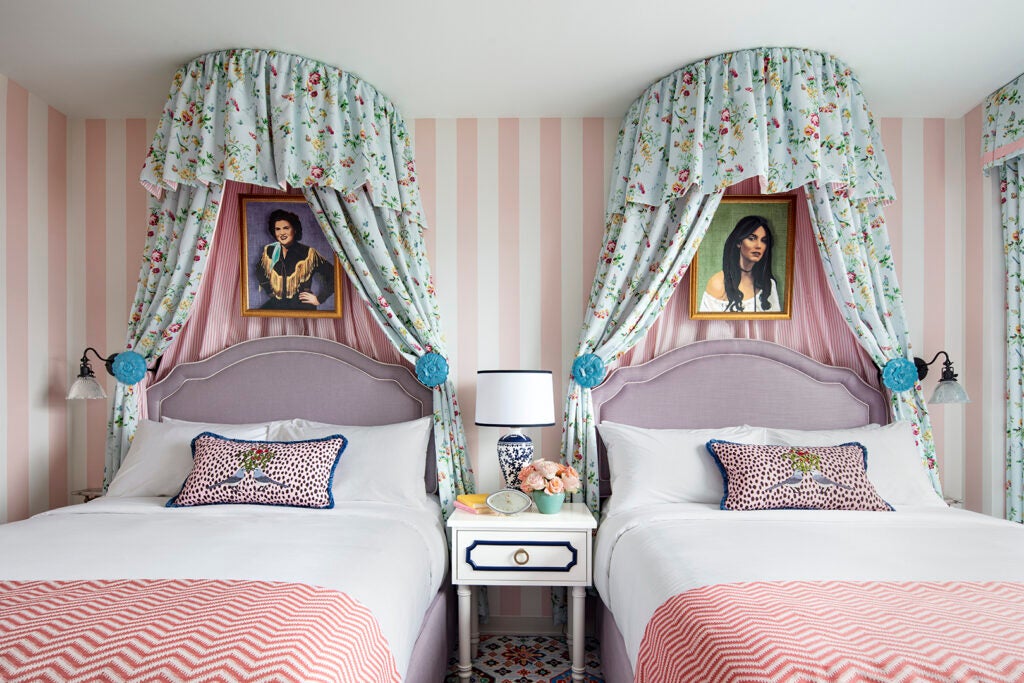 pink striped bedroom with canopy beds.