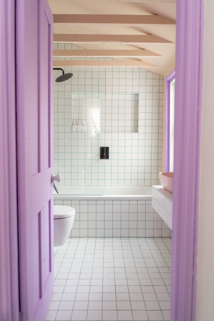 updated bathroom with purple door frame