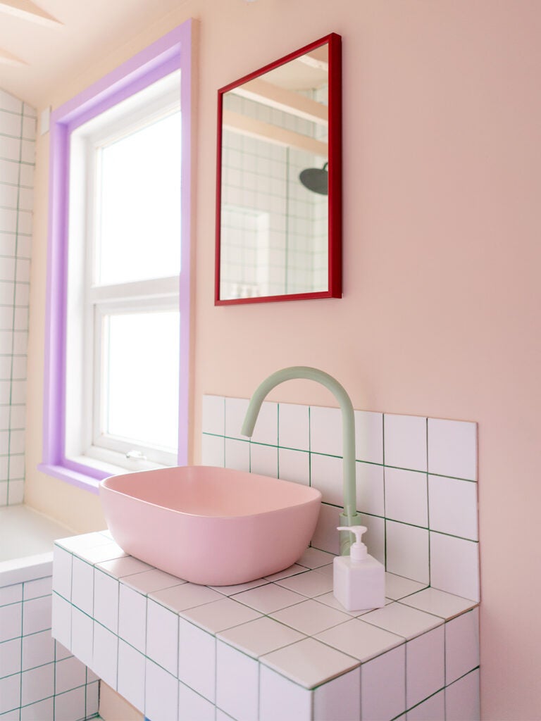 pink sink with green faucet