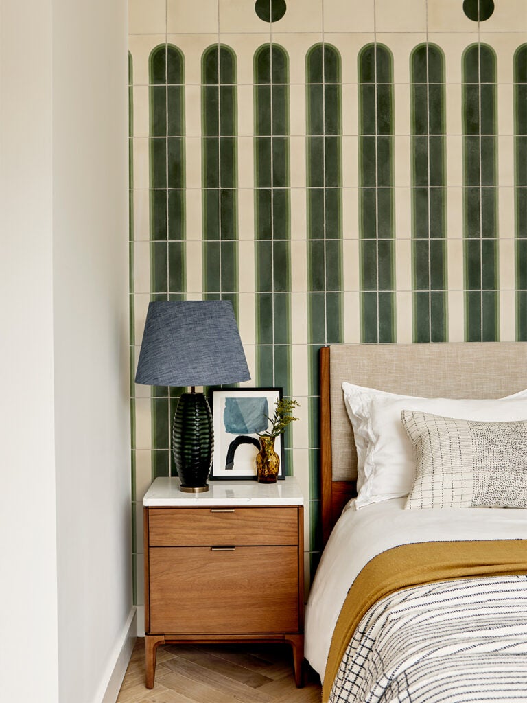green accent wall behind bed