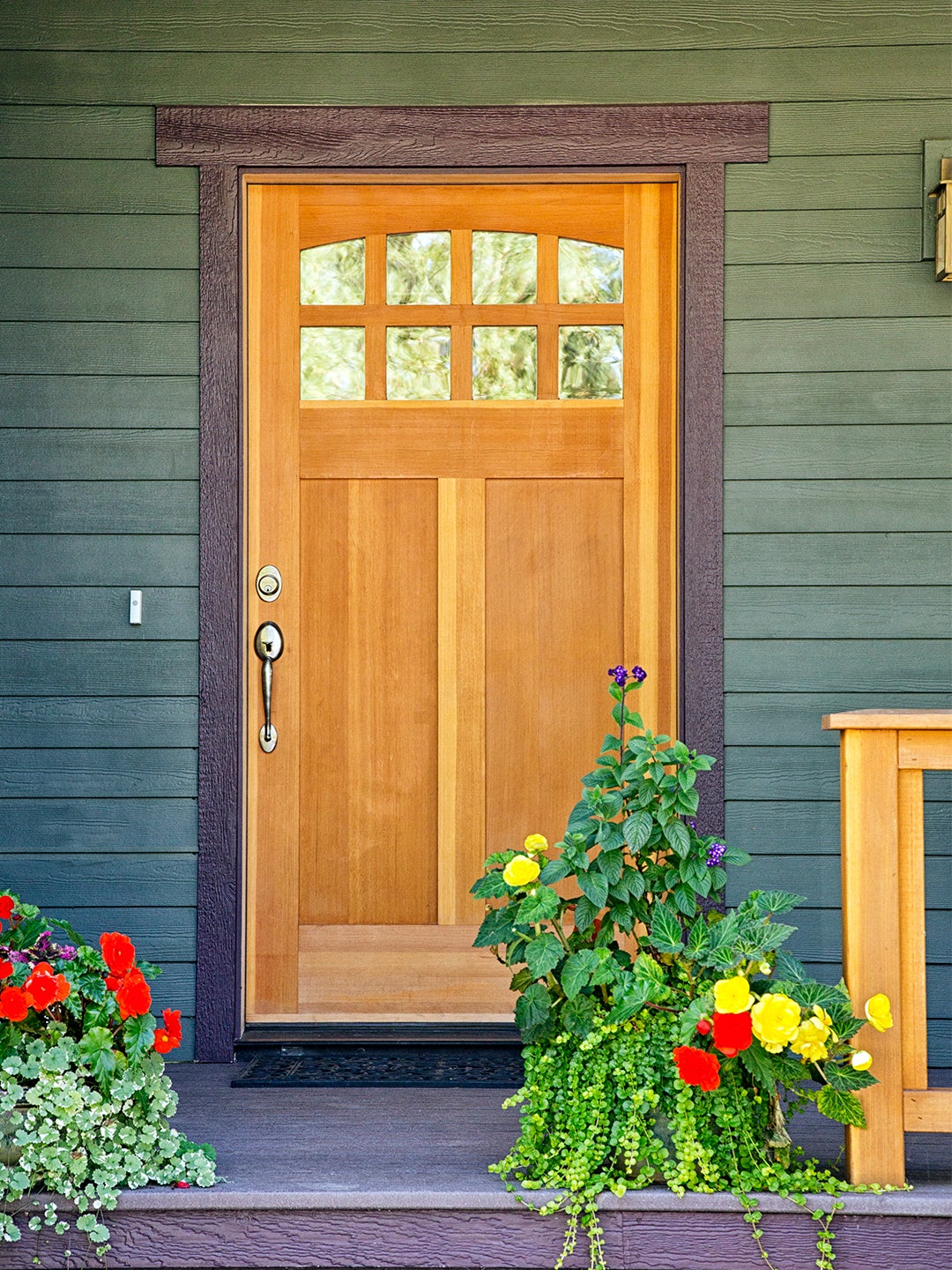 green home exterior with wood door