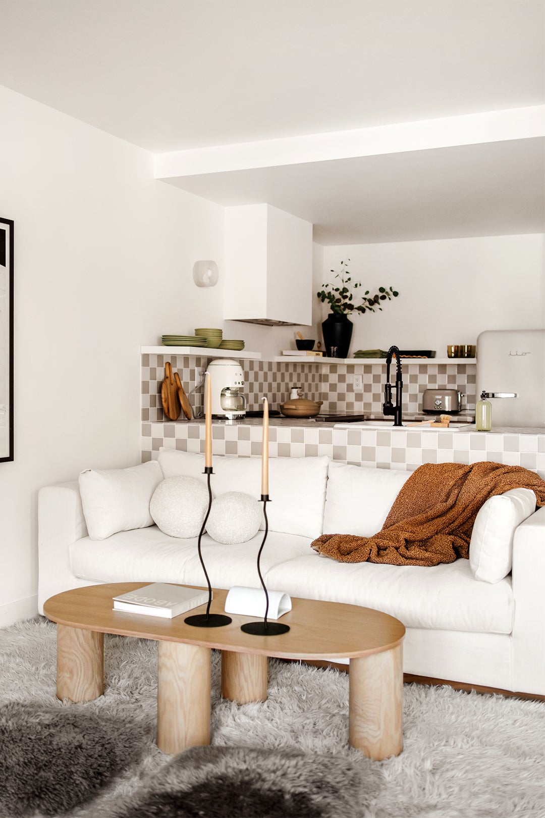 cozy white living room open to kitchen