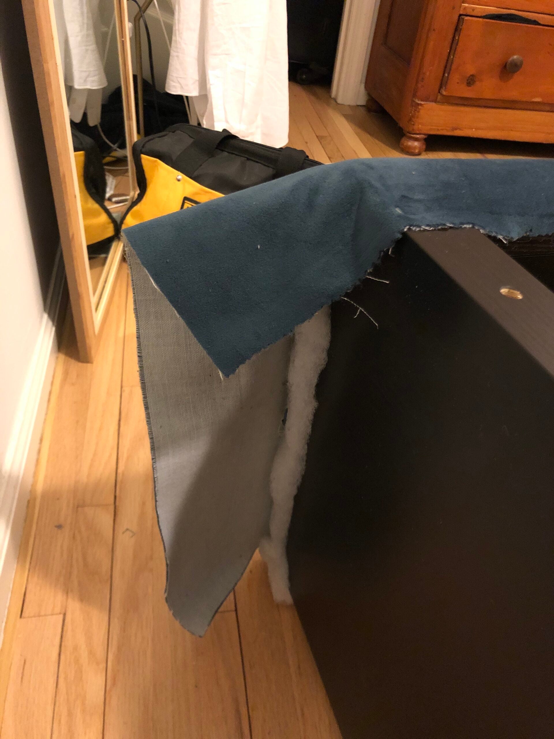 fabric hanging over bed frame edge