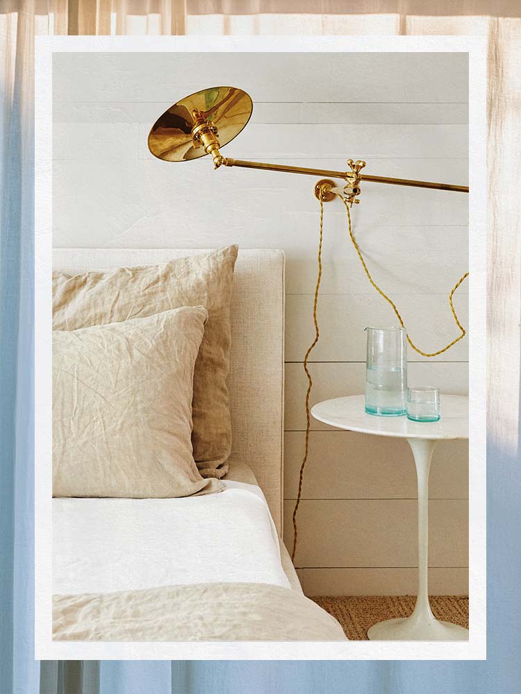 Beige Bedding and Pillowcase with Brass Wall Light