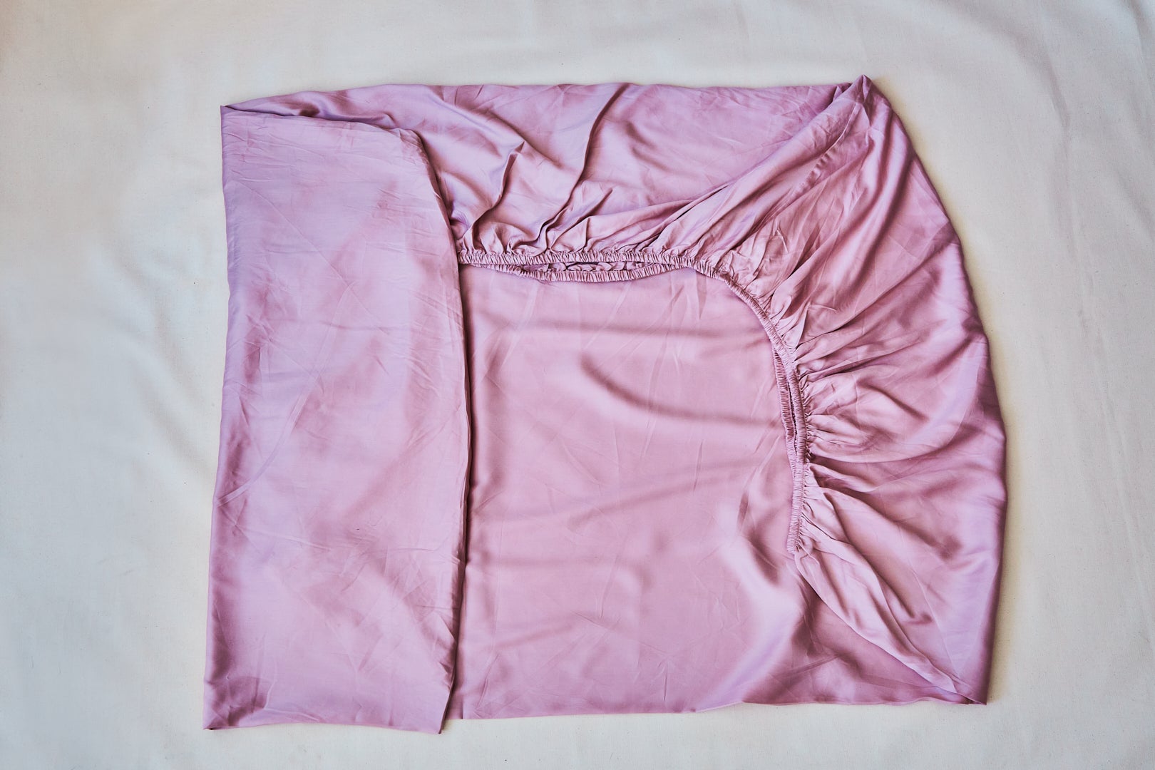 pink fitted folded sheet in a rectangle shape