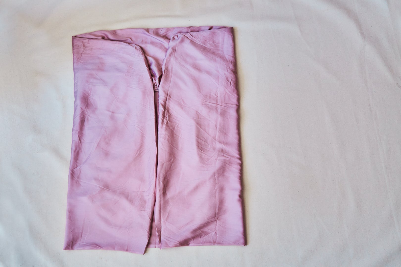 pink fitted folded sheet in a square