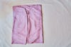 pink fitted folded sheet in a square