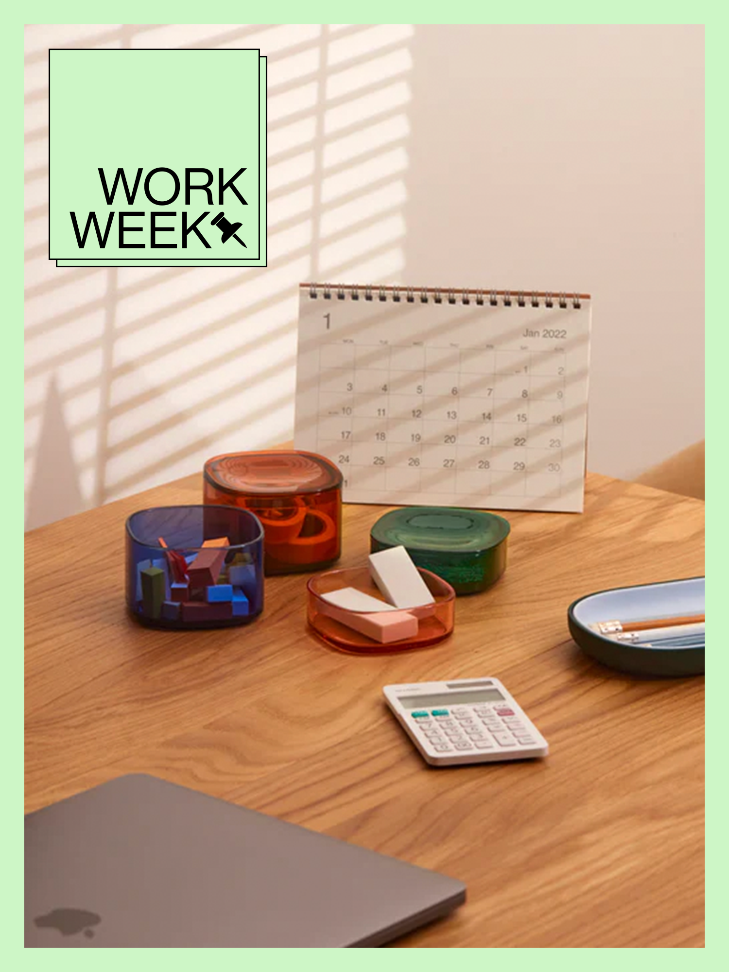 Open Spaces multi-color Storage Gems on walnut-wood desk with green Work Week design border and badge.