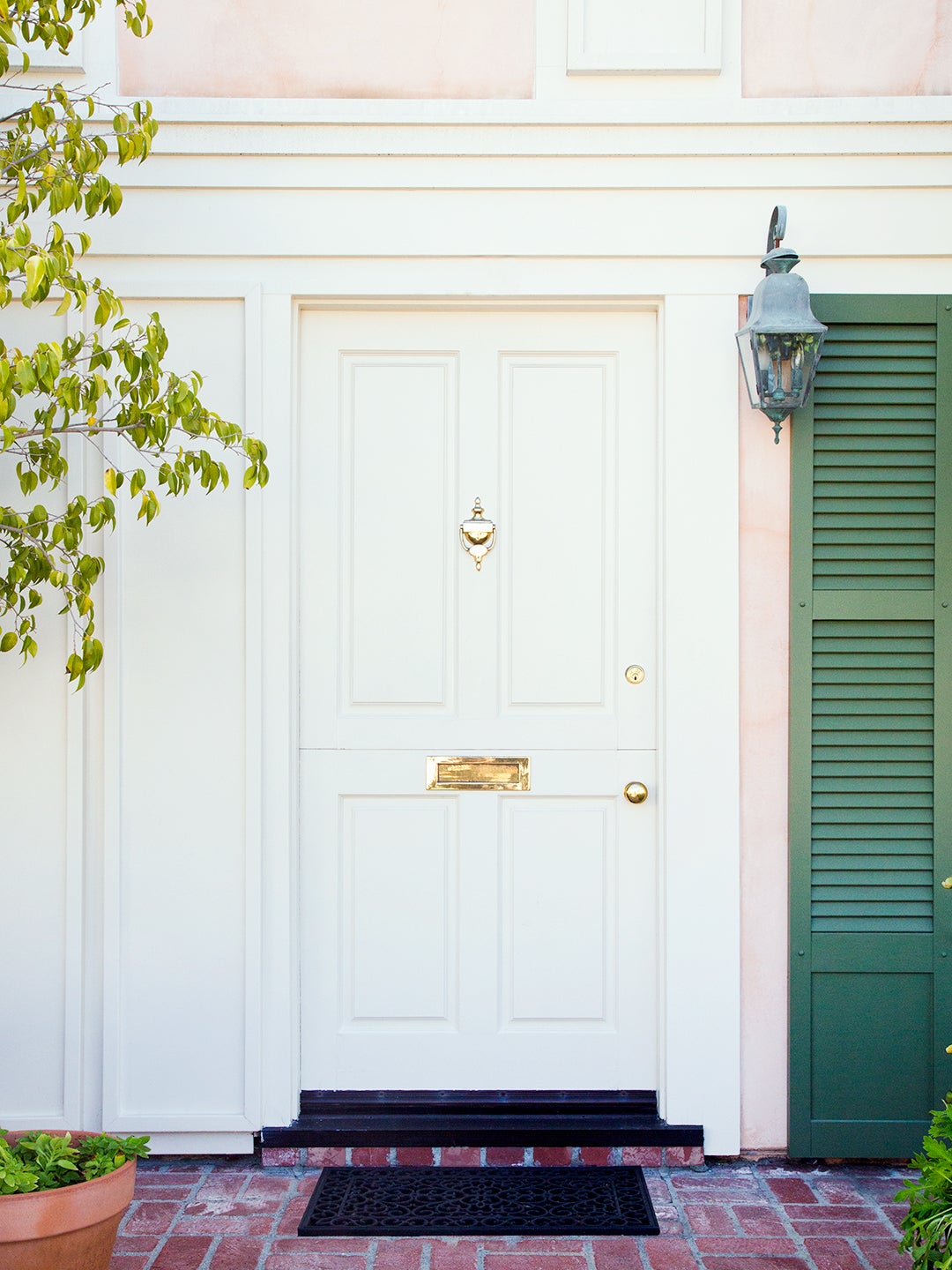 white exterior door with gold hardware